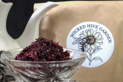 Dried hibiscus petals heaped in a cut-glass bowl.