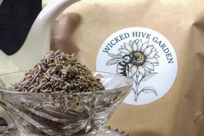 Dried lavender buds heaped in a cut-glass bowl.
