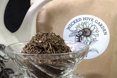 Dried lemon balm in a cut-glass bowl.
